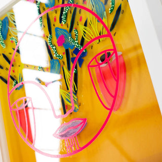 Colorful abstract art piece with pink and yellow elements on a yellow background