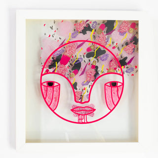 Framed artwork with a stylized face design and floral patterns on a light background